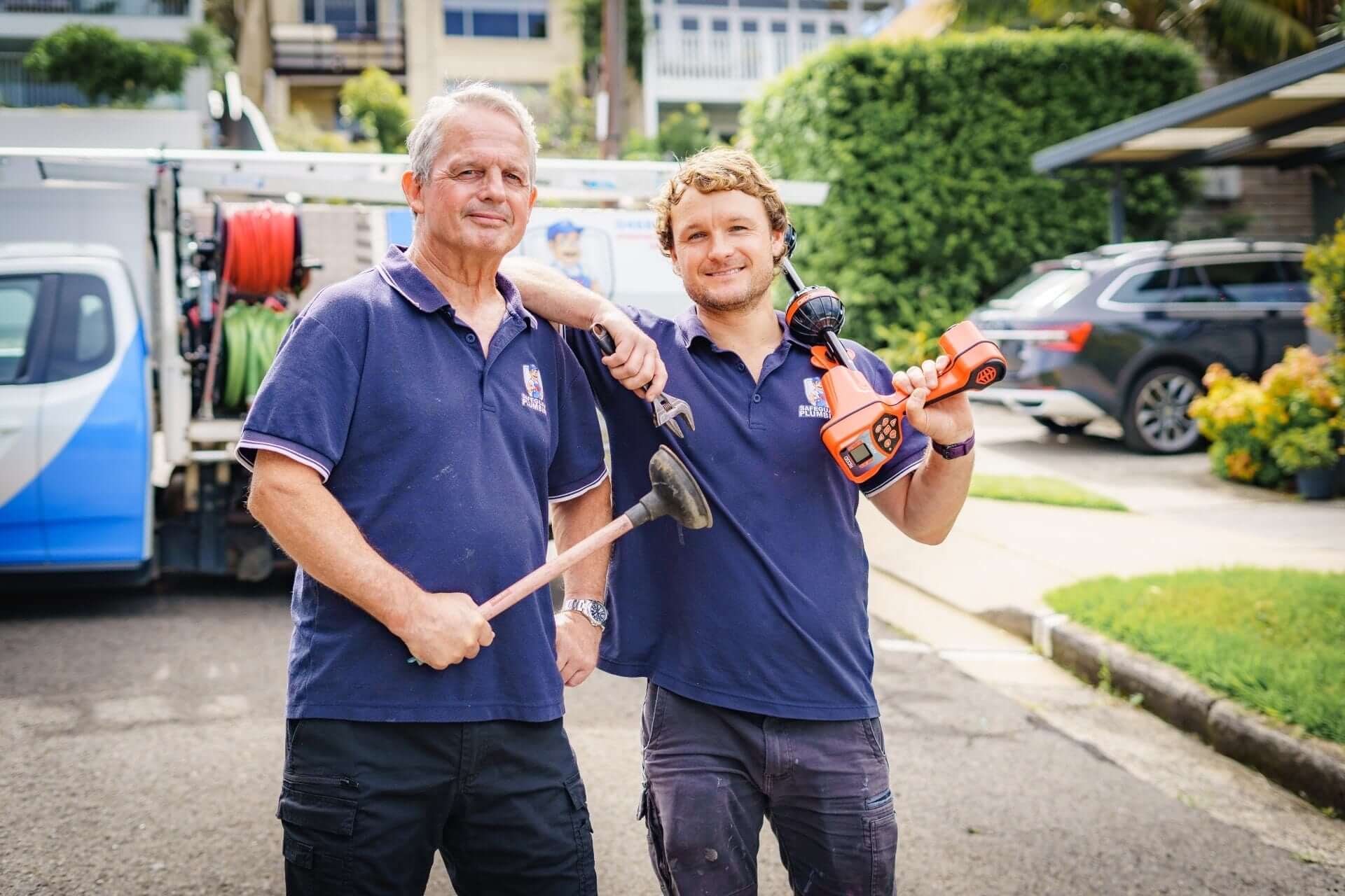 Father Michael and son Luke with their plumbing tools ready to serve you.